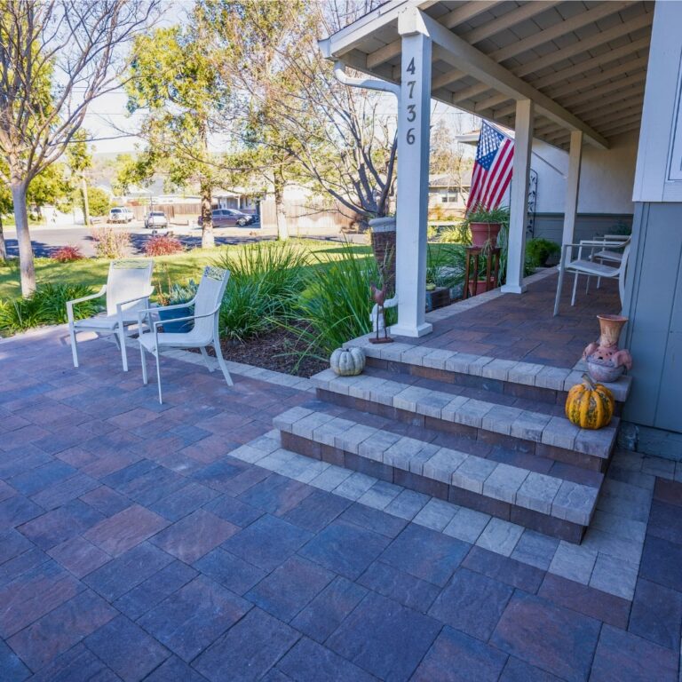 Side-by-side comparison of paver stones and a concrete patio surface