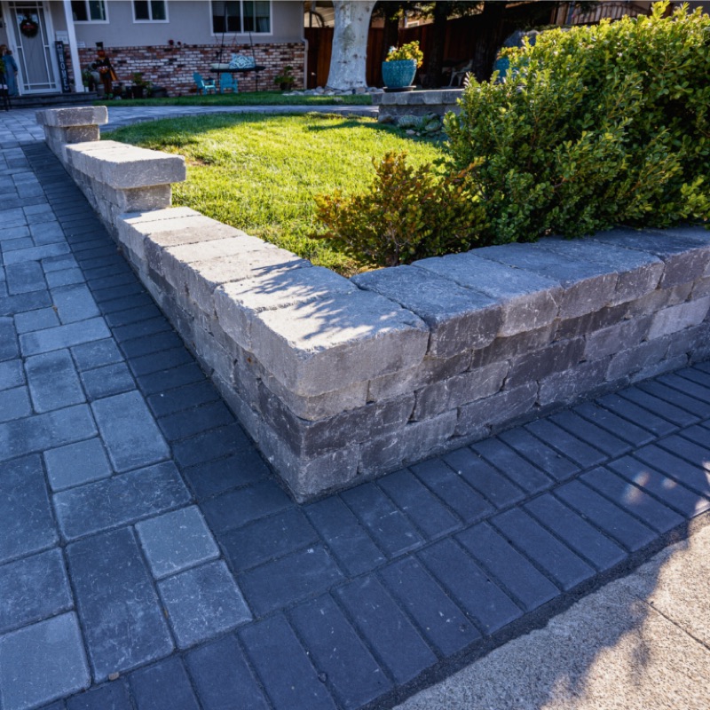 multi-tiered stacked stone retaining wall on steep slope
