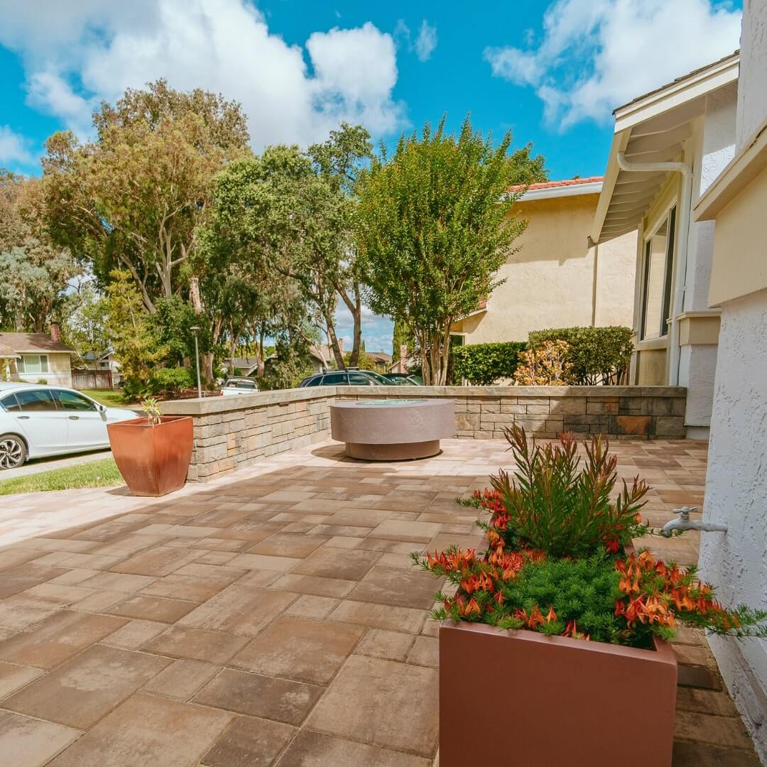 Custom hardscape patio combining rich paver borders and elegant textures Custom hardscape patio combining rich paver borders and elegant textures